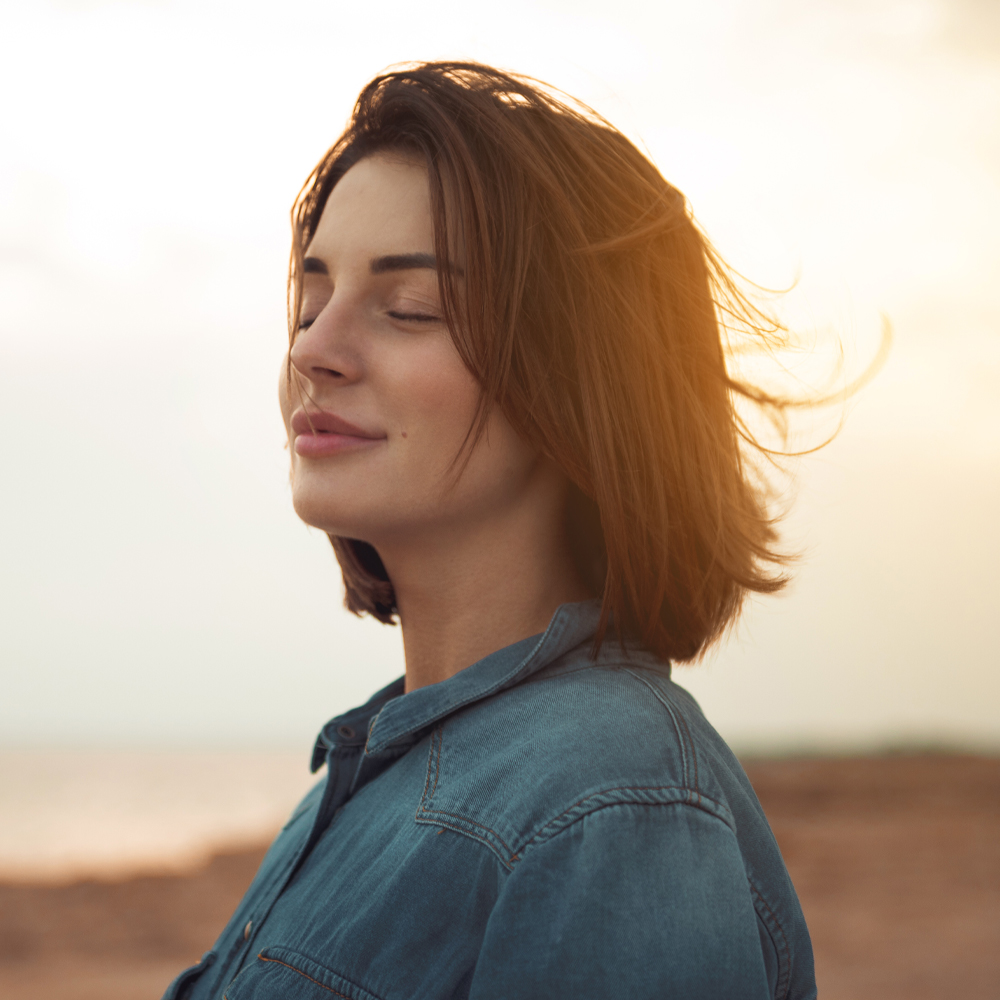 a woman standing on a beach