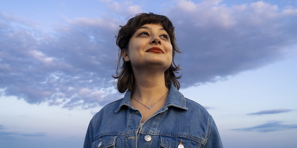 a person standing in front of a body of water