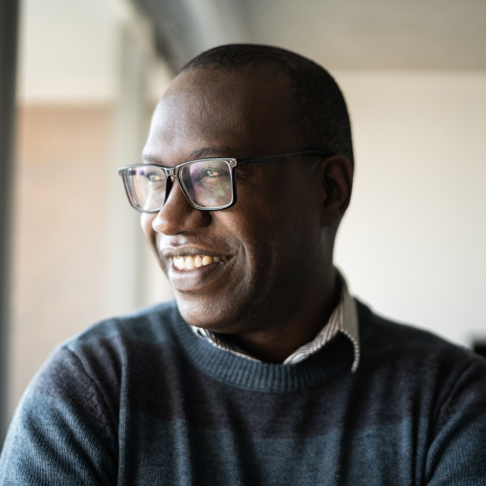 a man wearing glasses and looking at the camera