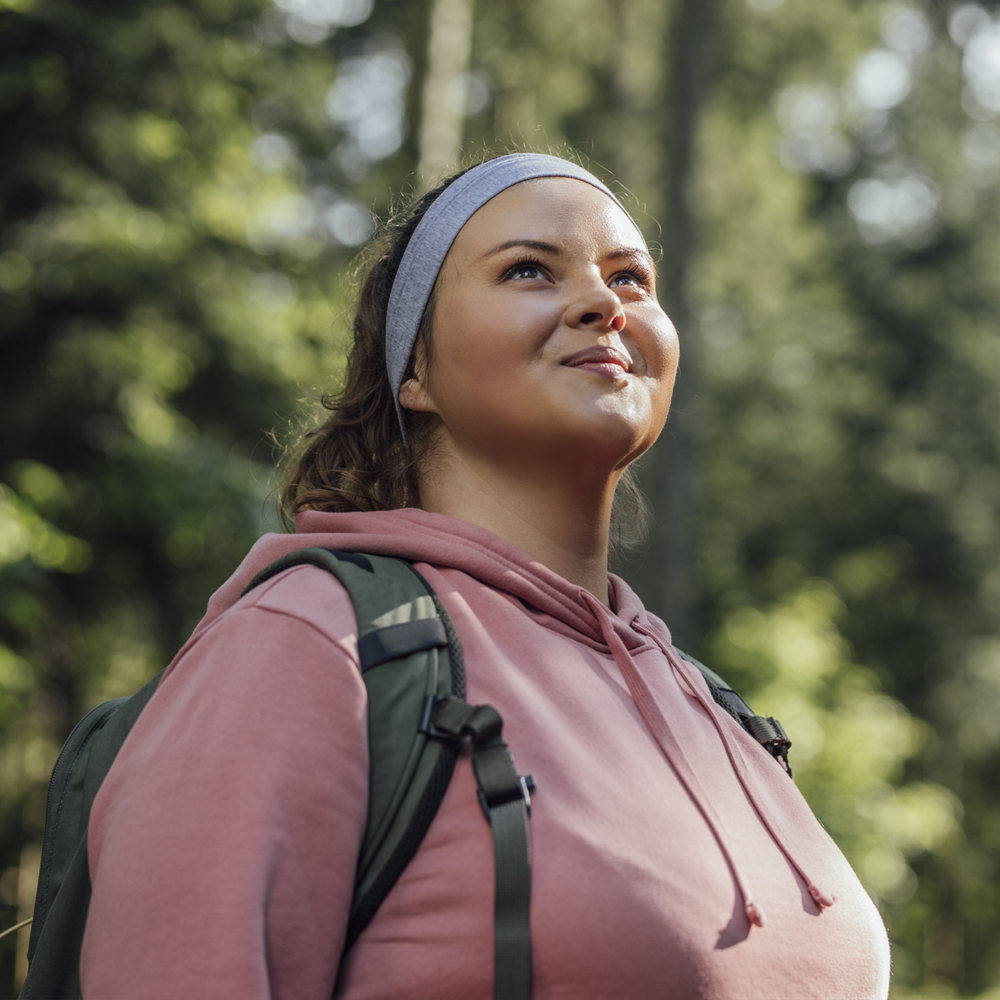 a person standing in front of a forest