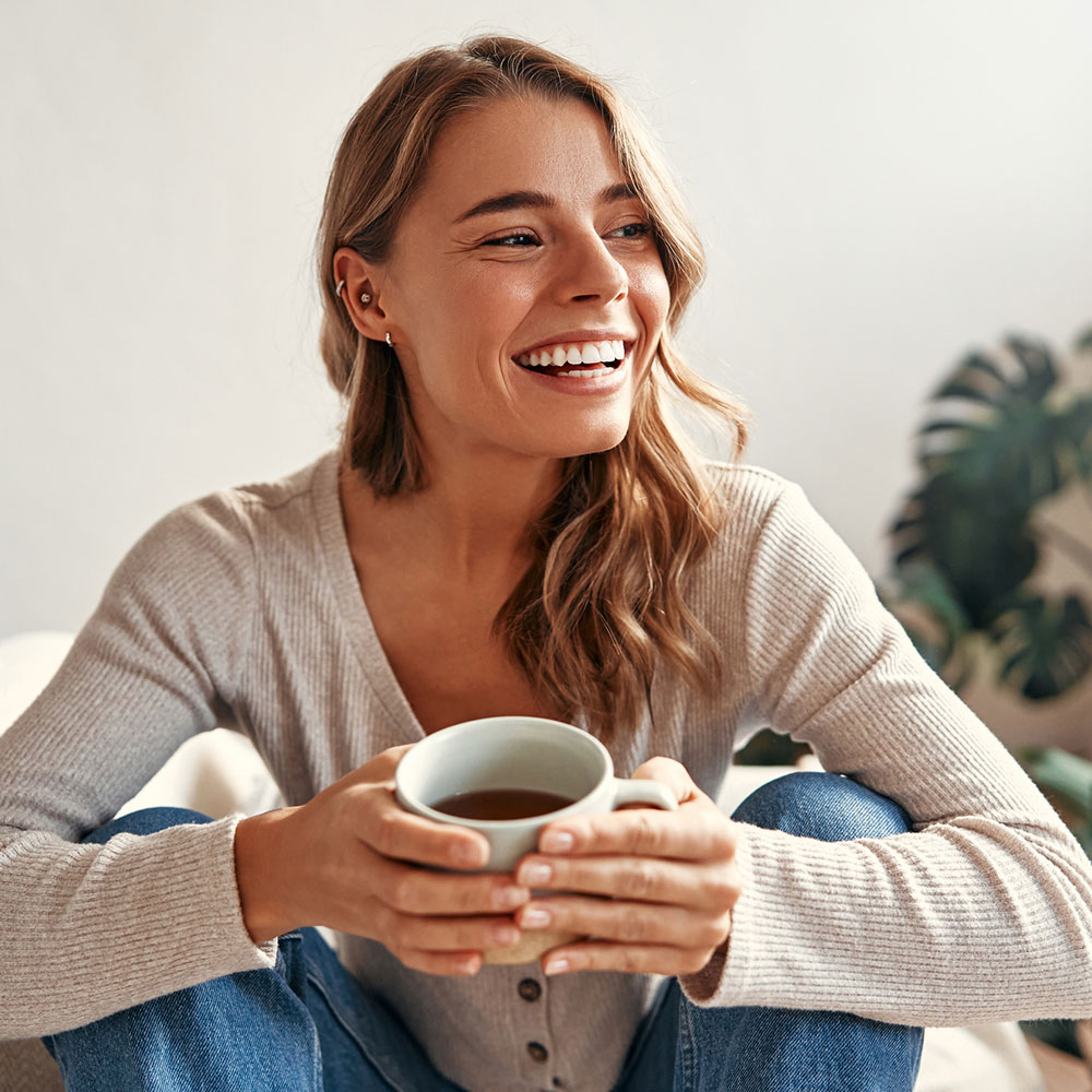 a woman holding a cup of coffee