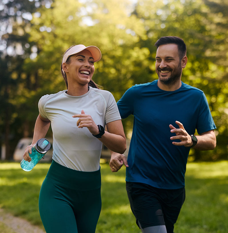 a woman holding a football ball on a field