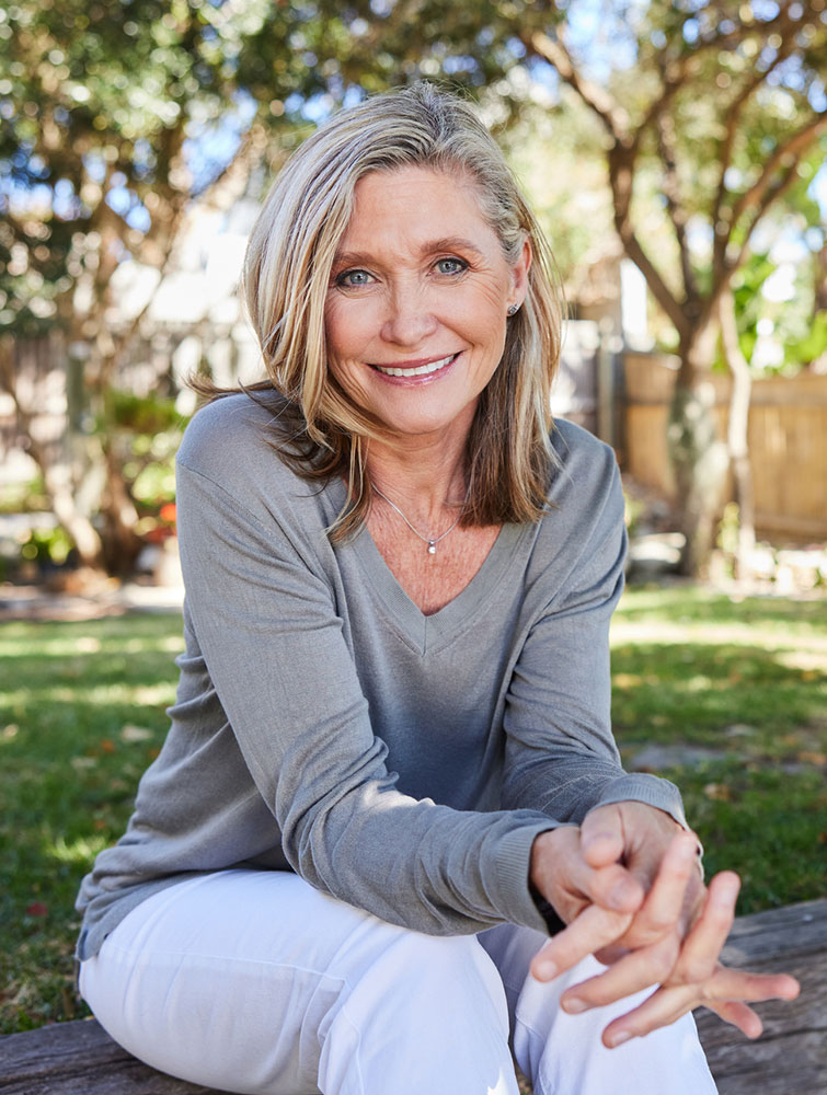 a woman sitting on a bench in a park
